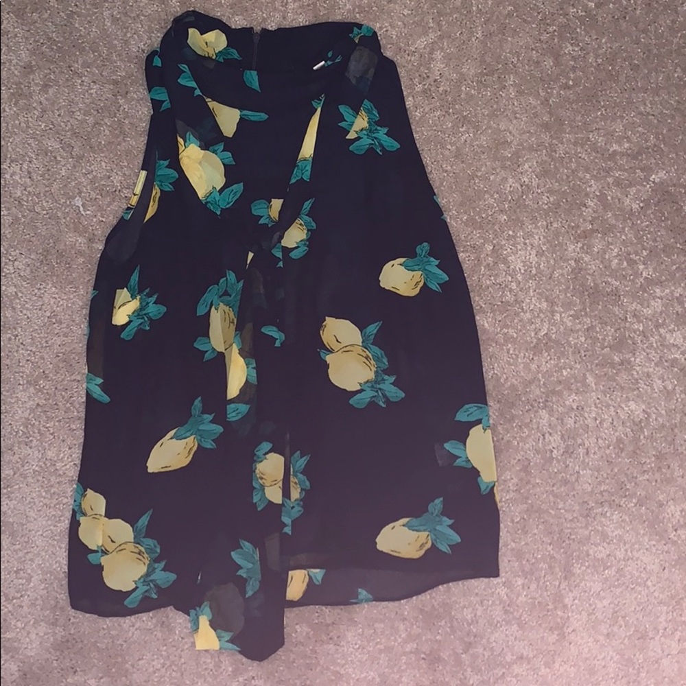 Sleeveless lemon blouse with ties at neck.
